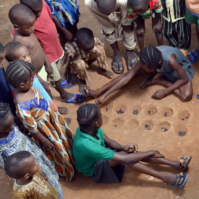 Kids Playing Ayo Game - Omagxii, CC BY-SA 4.0 , via Wikimedia Commons